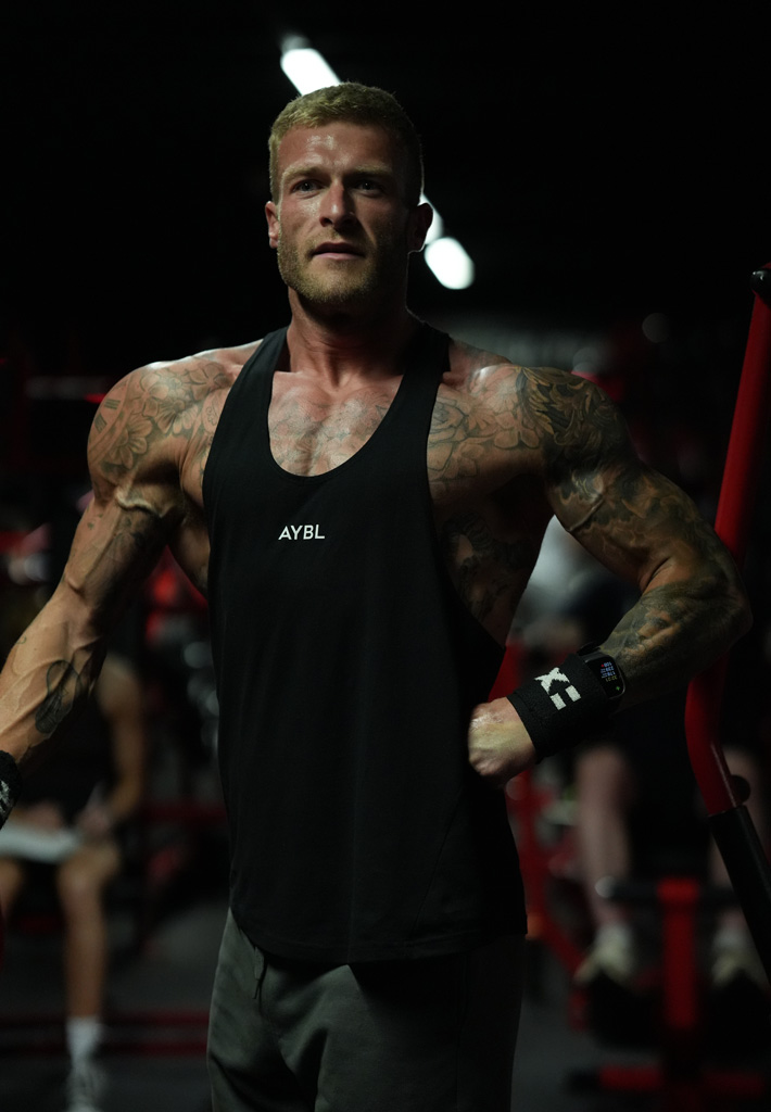 Coach is posing in the gym.
